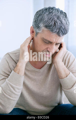 Ohrenschmerzen bei einem Mann Stockfoto