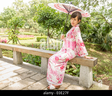 Chinesische Dame tragen Kimono im traditionellen japanischen Stil Garten Stockfoto