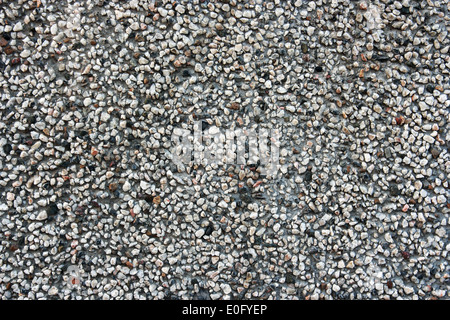 Hintergrund mit sehr kleinen Steinen hautnah. Asphalt-Nahaufnahme. Stockfoto