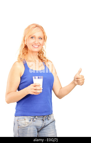 Reife Frau hält ein Glas Milch und Daumen aufgeben Stockfoto