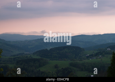 süße Atmosphäre in den Bergen nördlich von Tschechien mit dem Sonnenuntergang und mehrere kleine Berge im Frühling Stockfoto