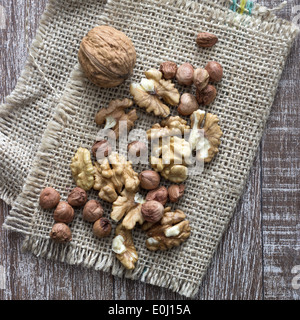 Walnüsse und Haselnüsse auf Holztisch, Nahaufnahme Stockfoto