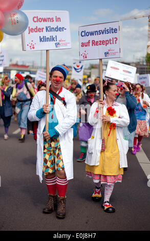 Berlin, Deutschland. 14. Mai 2014. Klinik-Clowns mit portest Zeichen, die gelesen "Clown Runde auf Rezept?" und "Clowns in jeder Kinderkrankenhaus" zu demonstrieren, während einer Kundgebung von der Dachorganisation der Klinik-Clowns in der medizinischen Versorgung in Berlin, Deutschland, 14. Mai 2014. Clowns aus Hamburg, Bremen, Tübingen und Köln kam nach Berlin, um an der Rallye teilnehmen. Foto: Christoph Schmidt/Dpa/Alamy Live News Stockfoto