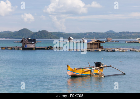 Traditionelles Boot und schwimmenden Hütten (verwendet, um Meeresfrüchte wachsen) – Landschaft der Ekas Bucht, gesehen aus Region der Ekas, Lombok, Indonesien Stockfoto