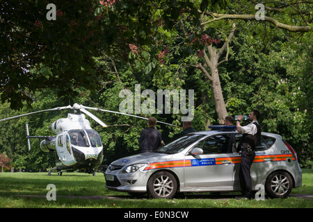 Trafen sich Polizei und MD902 Explorer Hubschrauber von der Kent, Surrey & Sussex Air Ambulance Trust vor Ort in Ruskin Park nach Notfall Flug nach Kings College Hospital in Südlondon. Stockfoto