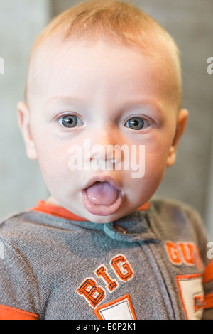 Niedliche Baby Boy Spielen auf der Bank in einem Park. Stockfoto