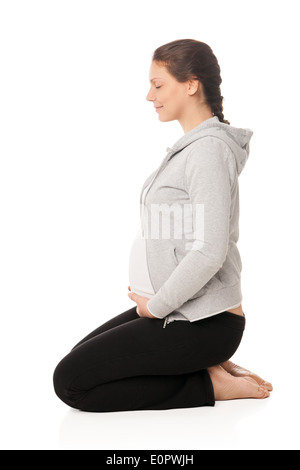 Schöne schwangere Frau lächelnd und Übungen isoliert Stockfoto