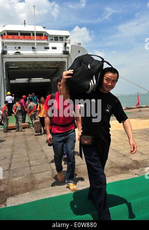 (140520)--HAIKOU, 20. Mai 2014 (Xinhua)--chinesische Staatsbürger Aussteigen aus dem Passagierschiff Tongguling nach des Schiffes im Hafen Xiuying in Haikou, der Hauptstadt der Provinz Süd-China Hainan, 20. Mai 2014 Ankunft.  Gewalt heimgesuchten chinesische Arbeiter in Vietnam kamen am Dienstag im Hafen von Haikou. Die chinesische Regierung schickte vier Schiffe am Sonntag Aufstand heimgesuchten chinesische Arbeiter in Vietnam zu evakuieren, wo schwere Gewalt gegen ausländische Unternehmen seit Mai 13 zwei chinesische Staatsbürger Tote und mehr als 100 Verletzte hinterlassen hat. (Xinhua/Guo Cheng) (Lfj) Stockfoto