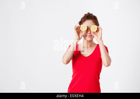eine Frau mit Zitrone Hälften Stockfoto