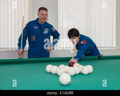 ISS-Expedition 41 backup Crewmitglieder, Terry Virts der NASA, links, und Samantha Cristoforetti der European Space Agency versuchen ihr Glück bei einer Partie Billard im Hotel Kosmonaut 21. Mai 2014 in Baikonur, Kasachstan. Expedition 41 startet am 29. Mai in das Raumschiff Sojus TMA - 13M von Baikonur aus für eine 5 ½ Monat mission auf der internationalen Raumstation ISS. Stockfoto