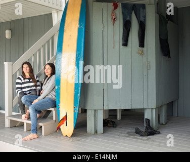 Surfer, die entspannend auf Terrasse Stockfoto