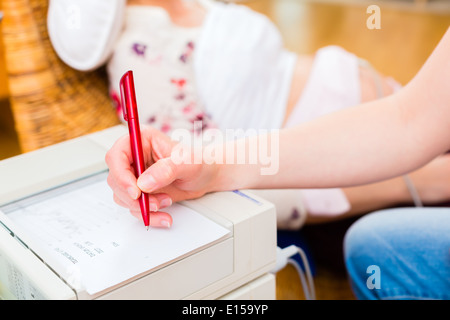 Hebamme, Prüfung Bauch der Schwangeren mit CTG Scannen in der Praxis Stockfoto