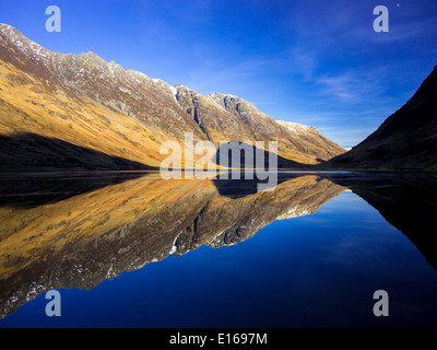 Aonach Eagach Ridge, spiegelt sich in den ruhigen Gewässern des Loch Achtriochtan, Glencoe, Schottisches Hochland. Stockfoto