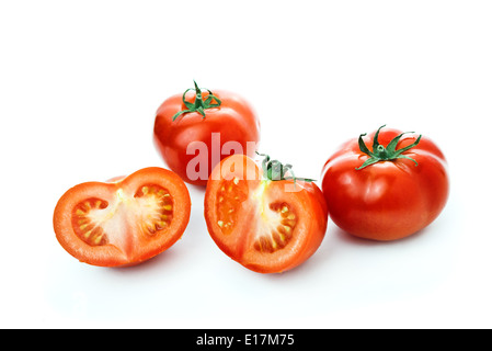 Frische rote Tomaten und eine halbe Scheiben auf weißem Hintergrund, leckere Bio-Gemüse für eine gesunde Ernährung. Stockfoto