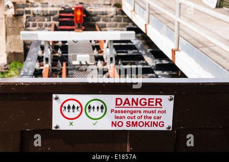 Warnschild im Inneren der Wagen eines Volks Railway-Schmalspur-Zuges. Stockfoto