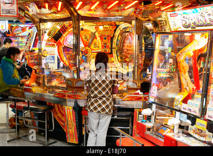 Menschen spielen auf eine Spielhalle in Tokio, Japan. Stockfoto