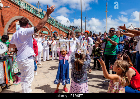 Kinder tanzen zu den Klängen von Silber Samba Band bei der Makrele Fayre, Brighton Seafront, Sussex, England Stockfoto