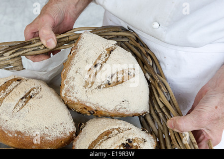 Baker, die holding Korb mit frisch gebackenem Brot Stockfoto