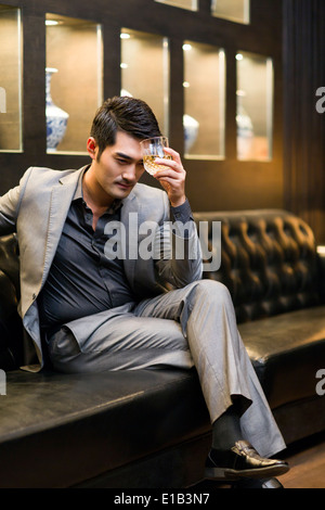 Junger Mann trinken von Alkohol in Luxus-club Stockfoto