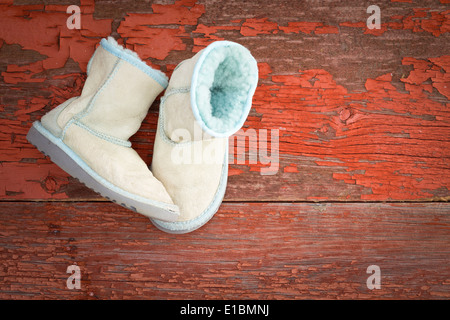 Gemütliche warme Winter Schaffell Hausschuhe mit flauschigen wolliges Fleece rustikale bg einen aufrechten und auf der Seite liegend gefüttert Stockfoto