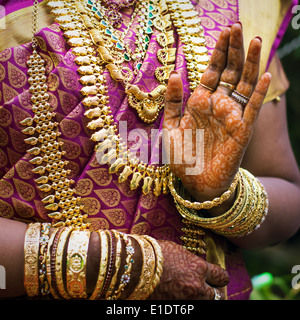 Die Hände eines indischen Braut geschmückt mit Schmuck, Armreifen und mit Henna bemalt Stockfoto