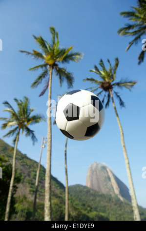 Fußball-Fußball-Ball fliegen in den Palmen am Pao de Acucar Sugarloaf Mountain Red Beach-Rio De Janeiro-Brasilien Stockfoto