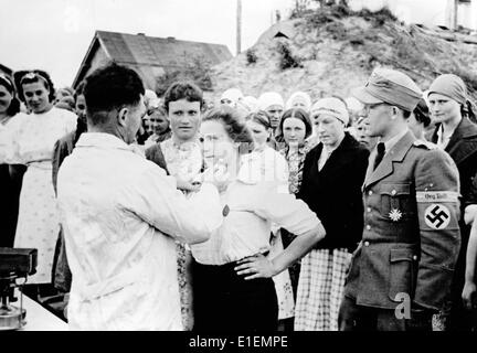 Das Nazi-Nachrichtenfoto zeigt, dass die einheimische Frau aus den von der deutschen Armee besetzten Gebieten der Ostfront vor ihrer Arbeit in der Todt-Organisation im Oktober 1943 geimpft wurde, Ort unbekannt. Eine Übersetzung der ursprünglichen Nazi-Propaganda in Deutsch lautet: Gesundheitswesen im Osten. Örtliche Freiwillige in der Todt-Organisation werden gegen Krankheiten geimpft. Fotoarchiv für Zeitgeschichte - KEIN KABELDIENST Stockfoto