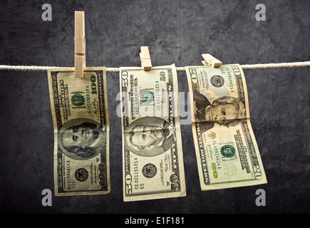 Amerikanische Währung. USA-Geld, Dollarscheine hängen am Seil mit Wäscheklammern befestigt. Stockfoto