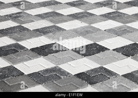 Schwarz graue und weiße Muster der städtischen am Straßenrand Pflaster Stockfoto