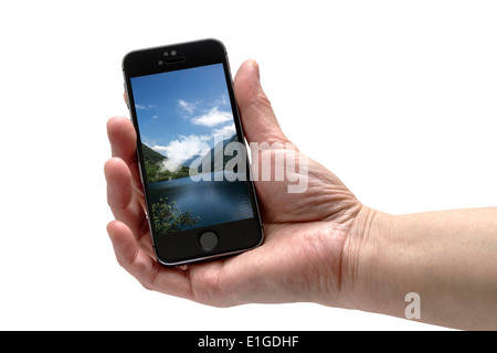 IPHONE 5 s in der Hand isoliert auf weißem Hintergrund Stockfoto
