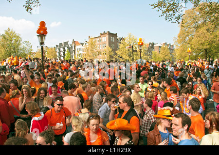 Große orange Menschenmenge feiern in den Straßen von Amsterdam an Könige in den Niederlanden Stockfoto