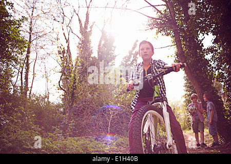 Junge auf Fahrrad im Wald Stockfoto