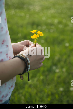 Junge Frau mit gelben Blüten, Nahaufnahme Stockfoto