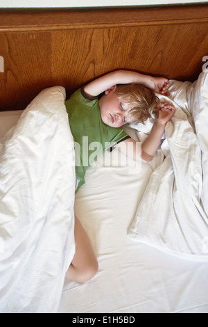 Kleiner Junge schlafen auf Bett Stockfoto