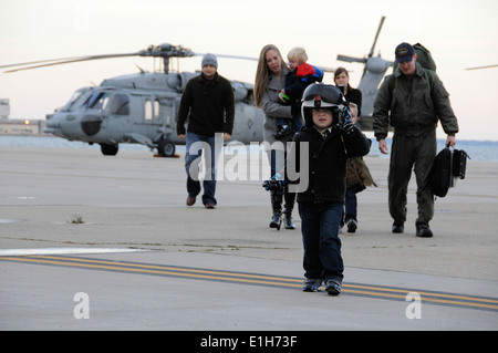 US Naval Air Crewman 2. Klasse Paul Steen? s Sohn, Front, trägt Helm seines Vaters Flug nach der Begrüßung ihn auf den Asphalt Dur Stockfoto