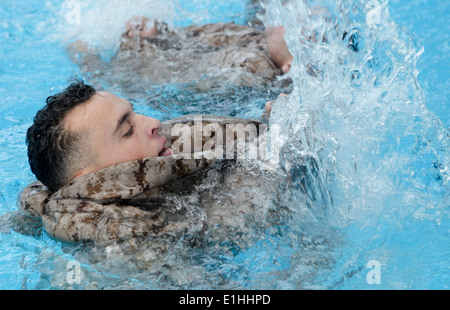 CPL. Andy Rodriguez Diaz spritzt Wasser um zu versuchen und seine Hose im Marine Corps Wasser Survival Training im Bereich aufblasen Stockfoto