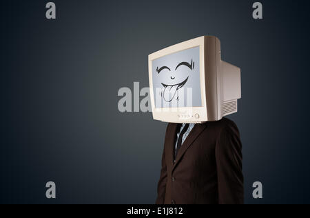 Glücklich Geschäftsmann mit einem Computer-Monitor und ein Smiley-Gesicht Stockfoto