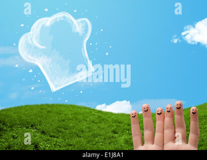 Glücklichen Smiley Gesicht Finger Blick auf Abbildung der Koch Hut Stockfoto