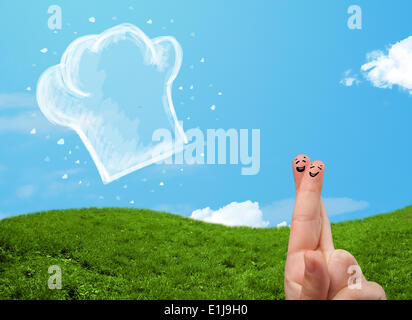 Glücklichen Smiley Gesicht Finger Blick auf Abbildung der Koch Hut Stockfoto
