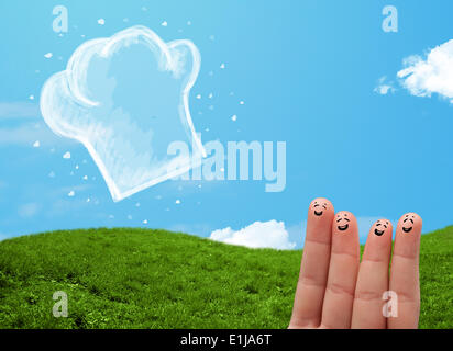 Glücklichen Smiley Gesicht Finger Blick auf Abbildung der Koch Hut Stockfoto