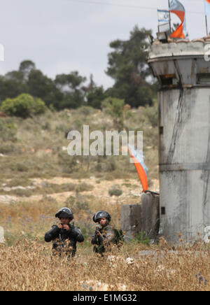 Ramallah, Palästina. 6. Juni 2014. Ramallah, Westjordanland, Palästina: Eine israelische Soldatin Gummigeschosse abgefeuert während der Demonstration in Solidarität mit den palästinensischen Gefangenen in israelischen Gefängnissen, im Westjordanland-Dorf von Nabi Saleh, in der Nähe von Ramallah am 6. Juni 2014. Mehr als 120 Palästinenser ohne Prozess in Israel wurden auf einen unbefristeten Hungerstreik im Gefängnis, nur Salz essen und trinken Wasser, seit dem 24. April, fordern ein Ende der sogenannten "Administrativhaft" Credit: Abdalkarim Museitef/NurPhoto/ZUMAPRESS.com/Alamy Live News Stockfoto