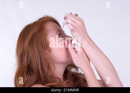 Frau Anwendung Latanoprost Auge Tropfen für die Behandlung des Glaukoms, die die Lösung für jedes Auge angewendet wird Stockfoto
