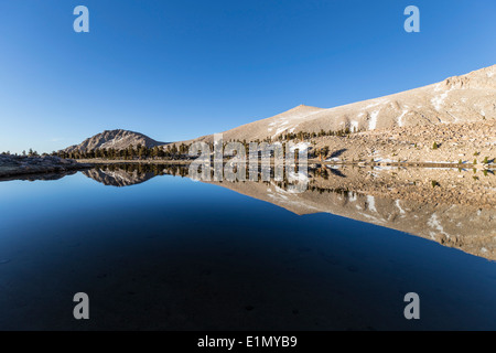 Ruhiges Wasser und Spiegel wie Reflexion an Cirque See hoch im kalifornischen südlichen Sierra Nevada Bergkette. Stockfoto