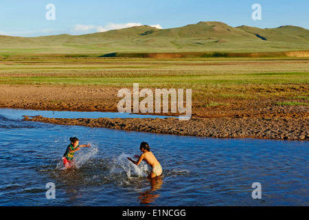 Mongolei, Provinz Zavkhan, Nomaden Camp, Kinder spielen im Fluss Stockfoto