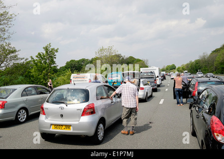 Die Leute stehen auf Fahrbahn außerhalb stehenden Fahrzeugen im Stau der Autos auf M6 durch Unfall verursacht lange Verzögerung. England Großbritannien Stockfoto