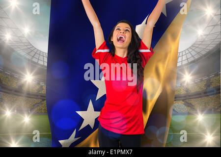 Zusammengesetztes Bild von jubelnden Fußball-Fan in rot mit bosnischen Flagge Stockfoto