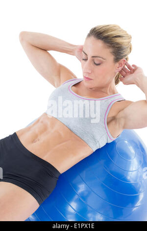 Fit Woman tun Sit Ups auf blau Gymnastikball Stockfoto