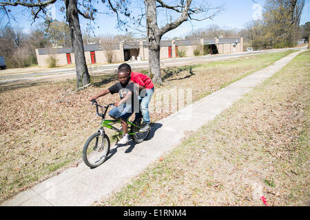 Crossett, Arkansas, USA. 16. März 2013. Kleinen Kindern fahren Rad durch die Preis-Grundschule in Crossett, Arkansas, die durch den hohen Grad von giftigen Chemikalien gefunden auf dem Grundstück heruntergefahren wurde. Nicolaus Czarnecki/ZUMAPRESS.com/Alamy © Live-Nachrichten Stockfoto