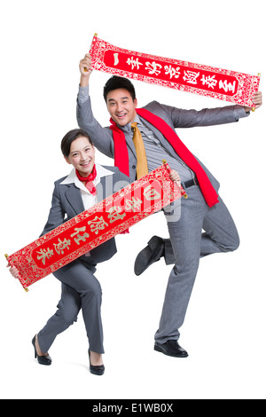 Geschäftsleute mit Couplets feiert Chinesisches Neujahr Stockfoto