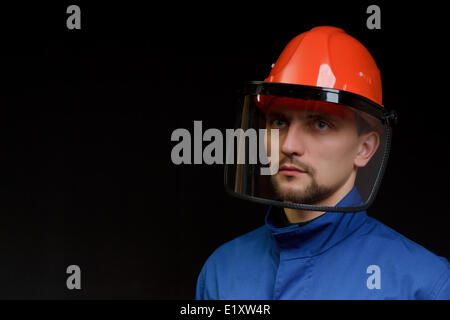 Die Arbeitskraft in Overall und Helm Stockfoto